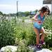 Chippewa Club supporter Skylar Mason-Schickel, 3, climbs through bushes at Skyline High School on Tuesday, July 23. She has two older sisters competing in the championships. Daniel Brenner I AnnArbor.com